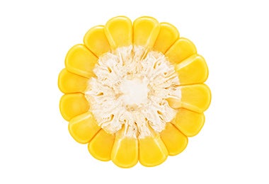 Granos de maíz amarillos organizados para que parezcan una flor