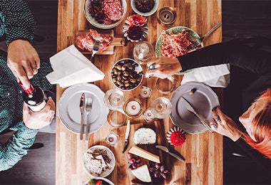 Mesa con tablas de embutidos, quesos y aceitunas