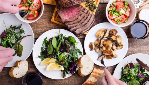 Mesa con comida y cuántas calorías se deben consumir al día según tus actividades y dieta