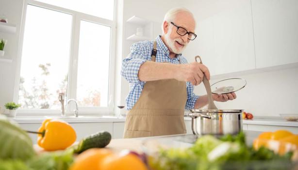 Un señor cocinando y gestionando bien su tiempo