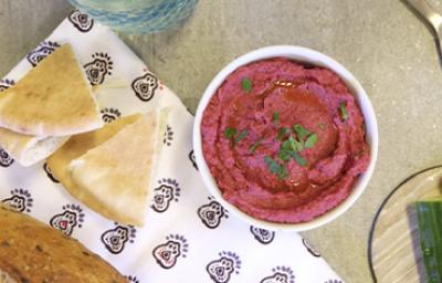 Recipiente con hummus de remolacha con pan pita Recipiente con hummus de remolacha con pan pita