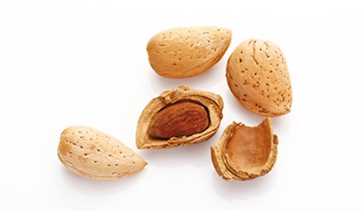 Frutos con cáscara enteros y partidos a la mitad pelar almendras